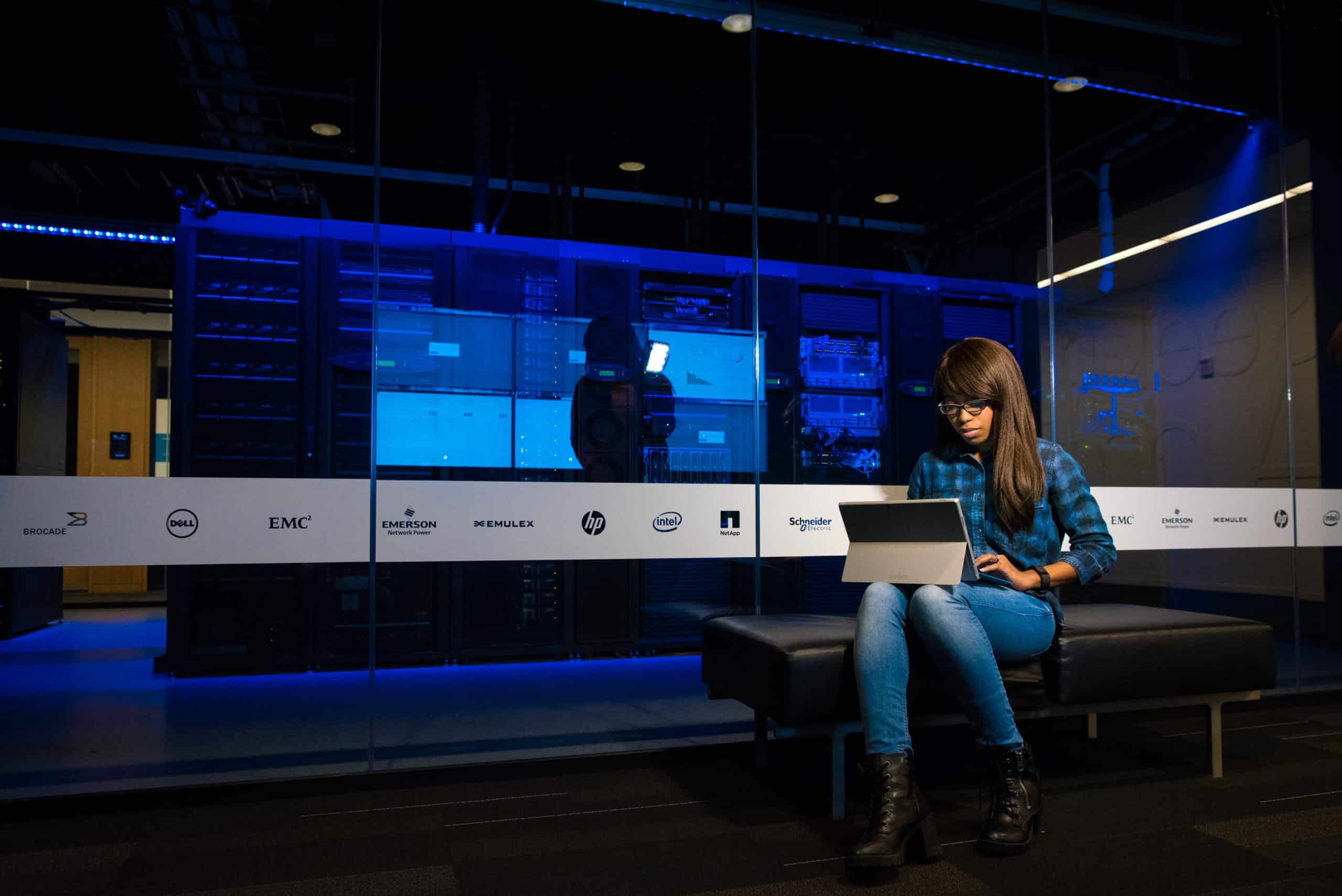 Datacenter employee working in front of data center floor